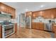Well-lit kitchen featuring stainless steel appliances, granite countertops, and plenty of wooden cabinet space at 5071 S Boston St, Greenwood Village, CO 80111