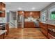 Spacious kitchen featuring stainless steel appliances, custom cabinets, and hardwood floors, ideal for cooking at 5071 S Boston St, Greenwood Village, CO 80111