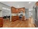 Well-lit kitchen featuring wood cabinets, modern appliances, and hardwood floors, providing a functional space at 5071 S Boston St, Greenwood Village, CO 80111