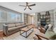 Inviting living room with hardwood floors, large window, a plush sofa, and two chairs with decorative pillows at 5071 S Boston St, Greenwood Village, CO 80111
