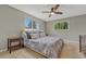 Calm main bedroom with soft carpet, ceiling fan, and view of trees outside two windows for natural light at 5071 S Boston St, Greenwood Village, CO 80111