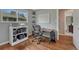 Cozy home office featuring a large window, white shelving, hardwood floors and a comfortable workspace at 5071 S Boston St, Greenwood Village, CO 80111