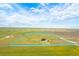 The bird's-eye view highlights the vast land included with the property, defined by a blue outline at 11680 Imboden Rd, Hudson, CO 80642