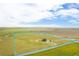 The aerial view showcases the house and its substantial acreage, marked by a blue boundary line at 11680 Imboden Rd, Hudson, CO 80642