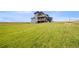 This expansive backyard with lush lawn provides a picturesque view of the home's exterior at 11680 Imboden Rd, Hudson, CO 80642