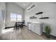 Contemporary bar area with modern cabinets, sink, floating shelves, accent decor, and ample natural light at 11680 Imboden Rd, Hudson, CO 80642