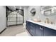 Modern bathroom with double sinks, stylish vanity, and elegant glass-enclosed shower with black accents at 11680 Imboden Rd, Hudson, CO 80642