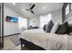 Cozy bedroom features a ceiling fan, bright windows, and built-in TV at 11680 Imboden Rd, Hudson, CO 80642