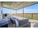 Covered deck area with comfortable seating and an outdoor fire pit at 11680 Imboden Rd, Hudson, CO 80642