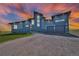 Stunning two-story home with modern design, three-car garage, unique roofline, and manicured lawn at 11680 Imboden Rd, Hudson, CO 80642