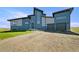 Beautiful two-story home with a unique roofline, modern facade, three-car garage and well-manicured front yard at 11680 Imboden Rd, Hudson, CO 80642
