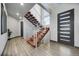 Bright foyer showcases a modern staircase with wood treads and minimalist railings, plus high ceilings at 11680 Imboden Rd, Hudson, CO 80642