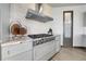 Modern kitchen with stainless steel range hood and range top, beautiful countertops and modern cabinets at 11680 Imboden Rd, Hudson, CO 80642