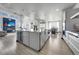 Open kitchen featuring a large island, stainless steel appliances, and seamless flow to the living area at 11680 Imboden Rd, Hudson, CO 80642