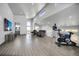 Spacious living room featuring an exercise bike, modern furniture, high ceilings, and clerestory windows at 11680 Imboden Rd, Hudson, CO 80642