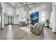 Bright living room features high ceilings, large windows, a fireplace, and sleek, modern design elements at 11680 Imboden Rd, Hudson, CO 80642