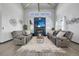 Spacious living room with high ceilings, cozy seating, a modern fireplace, and ample natural light at 11680 Imboden Rd, Hudson, CO 80642