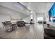 Open living area with high ceilings, clerestory windows, comfortable seating, modern exercise equipment and stylish decor at 11680 Imboden Rd, Hudson, CO 80642