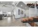Open-concept living area featuring high ceilings, sleek stairs, hardwood floors, and large windows at 11680 Imboden Rd, Hudson, CO 80642