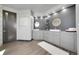 A clean, bright bathroom with dual vanities, modern lighting, and a separate toilet room at 11680 Imboden Rd, Hudson, CO 80642