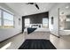Bright main bedroom boasts a modern design, dark accent wall, and ensuite bath featuring a soaking tub at 11680 Imboden Rd, Hudson, CO 80642