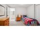 Cozy bedroom featuring a bright single bed, adjacent to the bathroom at 5331 S Geneva Way, Englewood, CO 80111