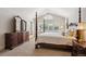 Well-lit bedroom with a four-poster bed, blinds, and a dresser at 5331 S Geneva Way, Englewood, CO 80111