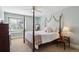 Comfortable bedroom with a four-poster bed, side table, and window with ample natural light at 5331 S Geneva Way, Englewood, CO 80111