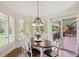 Breakfast area features a chandelier, sliding doors to a deck, and views of the trees at 5331 S Geneva Way, Englewood, CO 80111