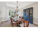 Elegant dining room boasts a large wooden table with seating for six, and views of the backyard at 5331 S Geneva Way, Englewood, CO 80111