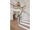 Grand foyer with beautiful staircase and chandelier is a welcome entrance at 5331 S Geneva Way, Englewood, CO 80111