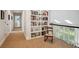 Upstairs hallway with built-in bookshelves and a rocking chair at 5331 S Geneva Way, Englewood, CO 80111