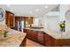 Gourmet kitchen featuring granite countertops, stainless appliances, and a central island at 5331 S Geneva Way, Englewood, CO 80111