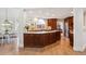 Open kitchen with granite countertops and stainless steel appliances, adjacent to breakfast area at 5331 S Geneva Way, Englewood, CO 80111