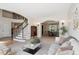 Open floor plan living room with hardwood floors, bright light, and decorative staircase at 5331 S Geneva Way, Englewood, CO 80111