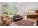 Open living room featuring shuttered windows, a leather sofa, and hardwood floors at 5331 S Geneva Way, Englewood, CO 80111