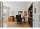 Private office with built-in shelving, desk, and natural light from shuttered window at 5331 S Geneva Way, Englewood, CO 80111