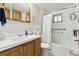 Clean bathroom with a vanity, mirror, bathtub, and shower featuring white tiles at 4909 W Mississippi Ave, Denver, CO 80219