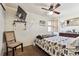 Cozy bedroom with a ceiling fan, mounted TV, and a window providing natural light at 4909 W Mississippi Ave, Denver, CO 80219