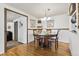 Dining room with hardwood floors and traditional table with seating for four at 4909 W Mississippi Ave, Denver, CO 80219