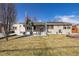 Well maintained single story home featuring solar panels, neutral colors, and mature trees at 4909 W Mississippi Ave, Denver, CO 80219