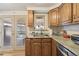 Light filled kitchen area with a marble-look counter top, stainless steel appliances, and an exit door at 4909 W Mississippi Ave, Denver, CO 80219