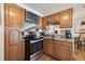 Light wood kitchen area with stainless steel range and microwave and marble-look backsplash and countertops at 4909 W Mississippi Ave, Denver, CO 80219