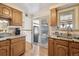 Marble-look countertop in a light wood kitchen with exit door and view into additional room at 4909 W Mississippi Ave, Denver, CO 80219