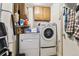 Functional laundry room equipped with a washer, dryer, and storage cabinets for convenience at 4909 W Mississippi Ave, Denver, CO 80219