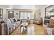 Bright and airy living room with hardwood floors, large window, and comfortable seating at 4909 W Mississippi Ave, Denver, CO 80219