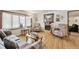 Comfortable living room featuring hardwood floors, a large window, and a cozy fireplace at 4909 W Mississippi Ave, Denver, CO 80219