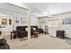 Relaxing living room with neutral carpet, cozy seating, and access to additional rooms at 4909 W Mississippi Ave, Denver, CO 80219