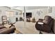 Spacious living room featuring neutral carpet, comfortable seating, and a flat screen television at 4909 W Mississippi Ave, Denver, CO 80219