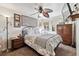 Comfortable bedroom featuring a ceiling fan, decorative artwork, and a window with natural light at 4909 W Mississippi Ave, Denver, CO 80219